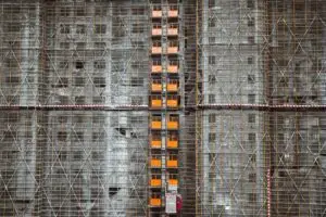 Detailed view of scaffolding on a construction site, featuring steel and concrete materials.